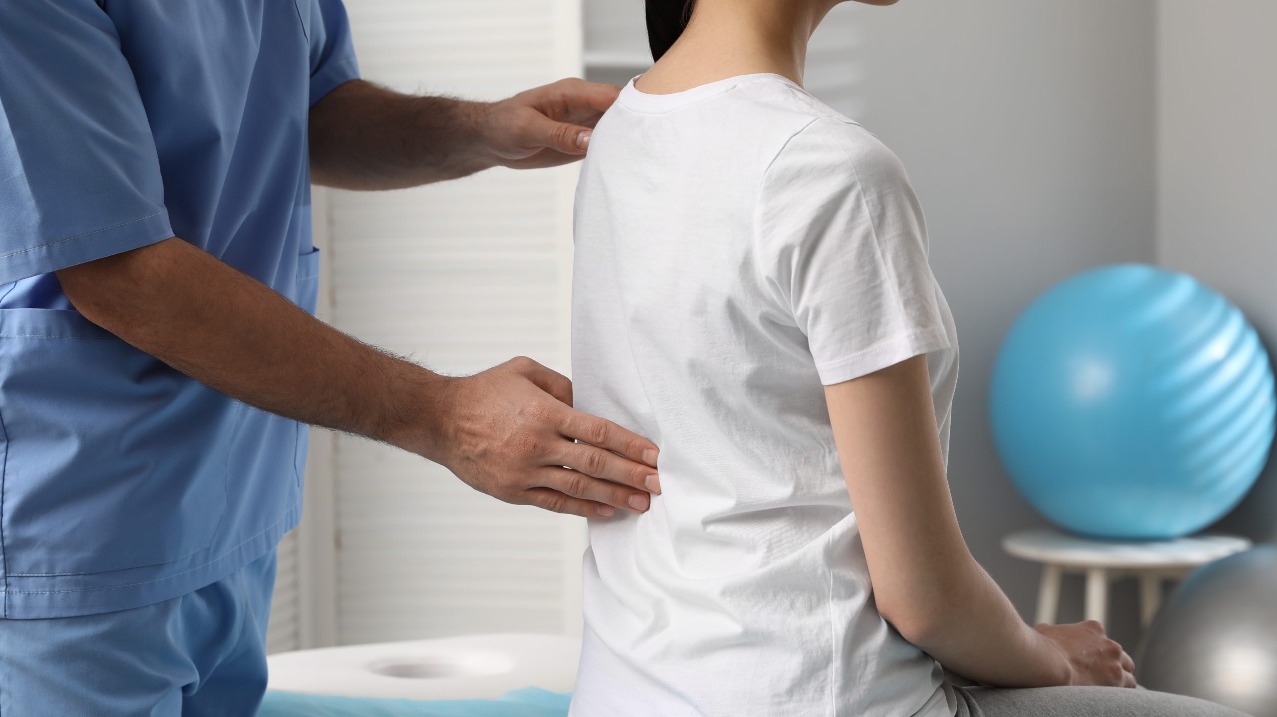 Doctor or Chiropractor helping restore postural health for a client