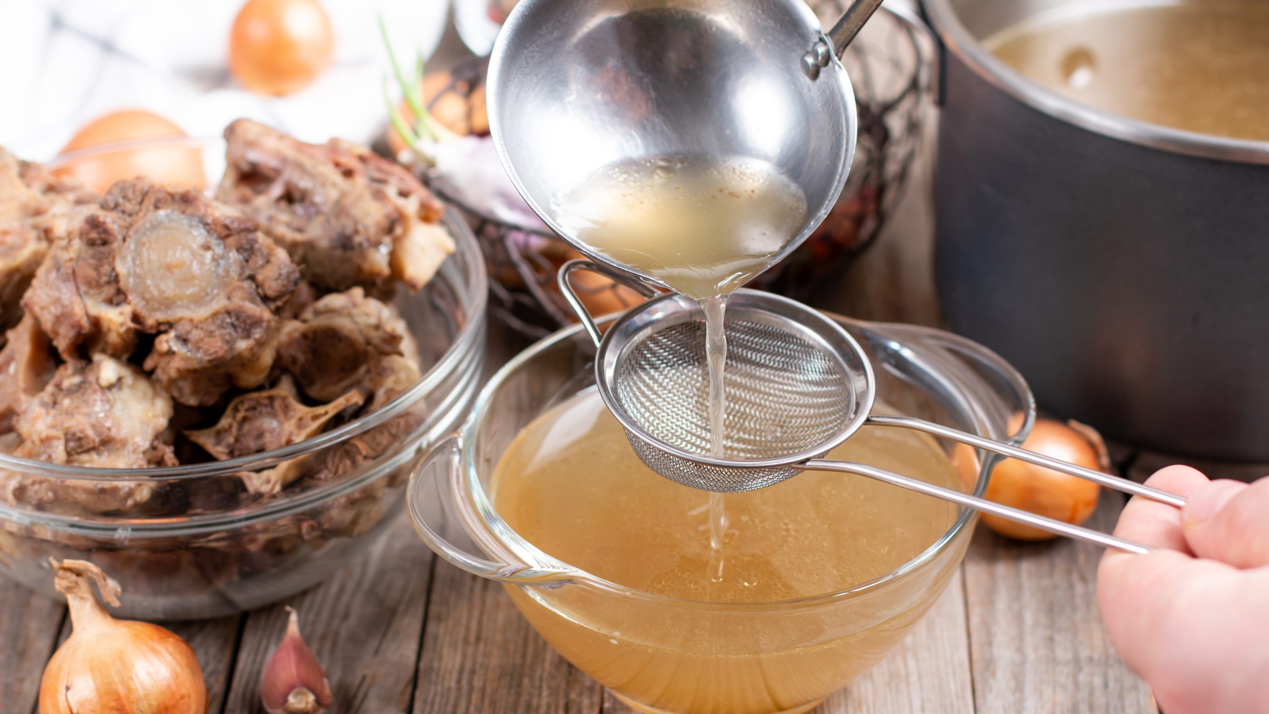 Person cooking bone broth for a collagen supplement