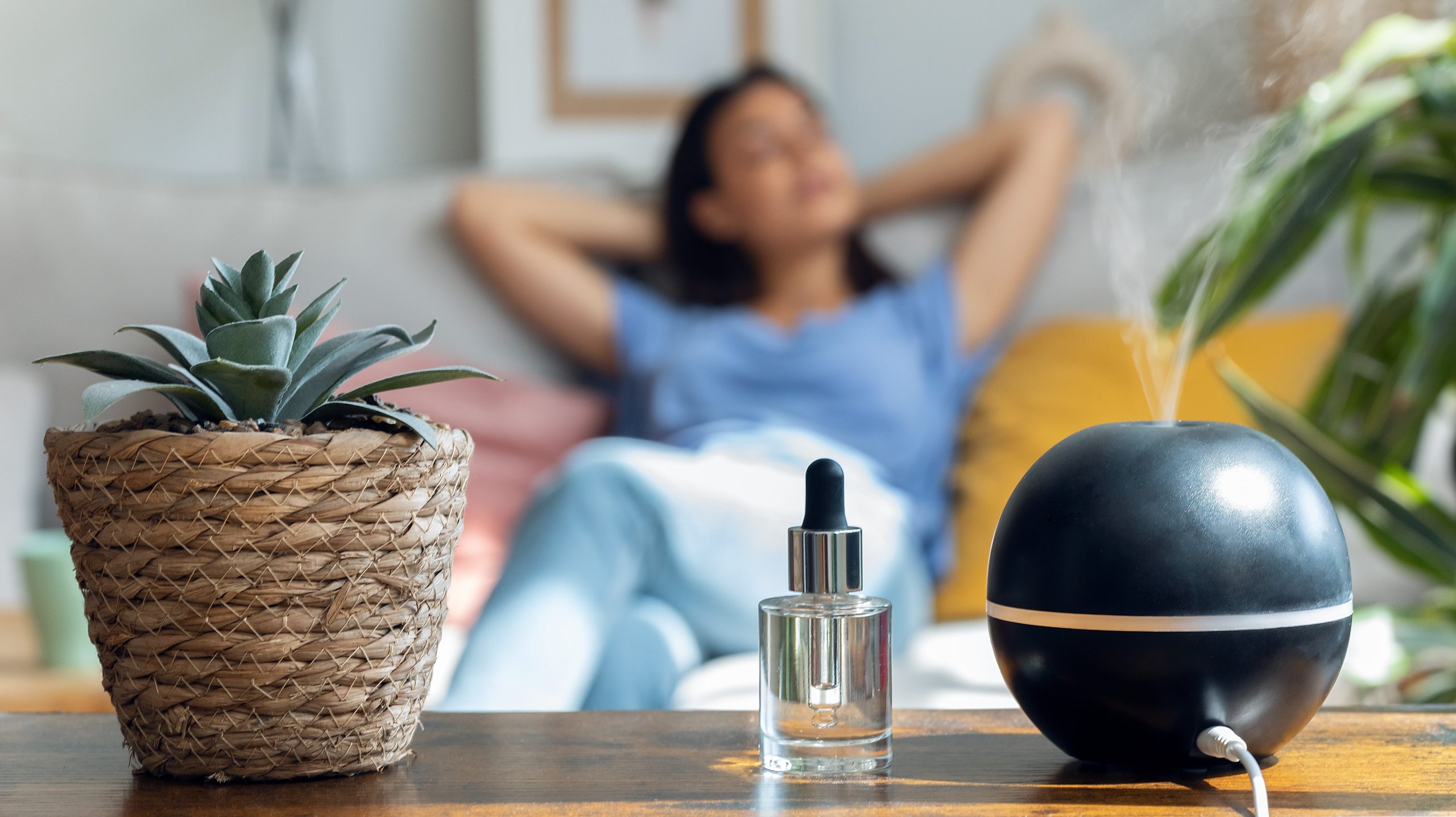 Woman getting rid of her headache with essential oils