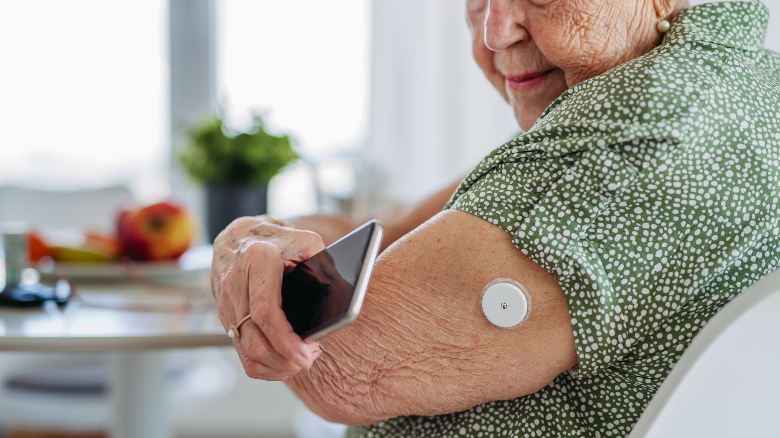 older woman with diabetes checking her blood sugar to reduce the risk of dementia